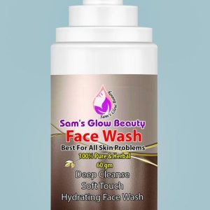 Sam’s Glow Beauty Facewash bottle on a natural stone surface surrounded by fresh herbs.